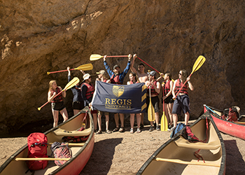 Student take group photo on canoeing trip