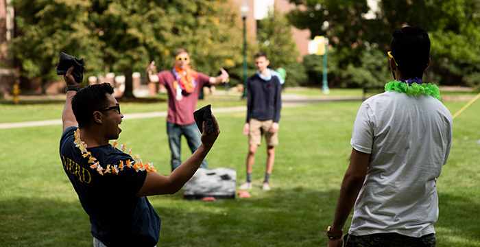 Student celebrate during a game of hacky sack