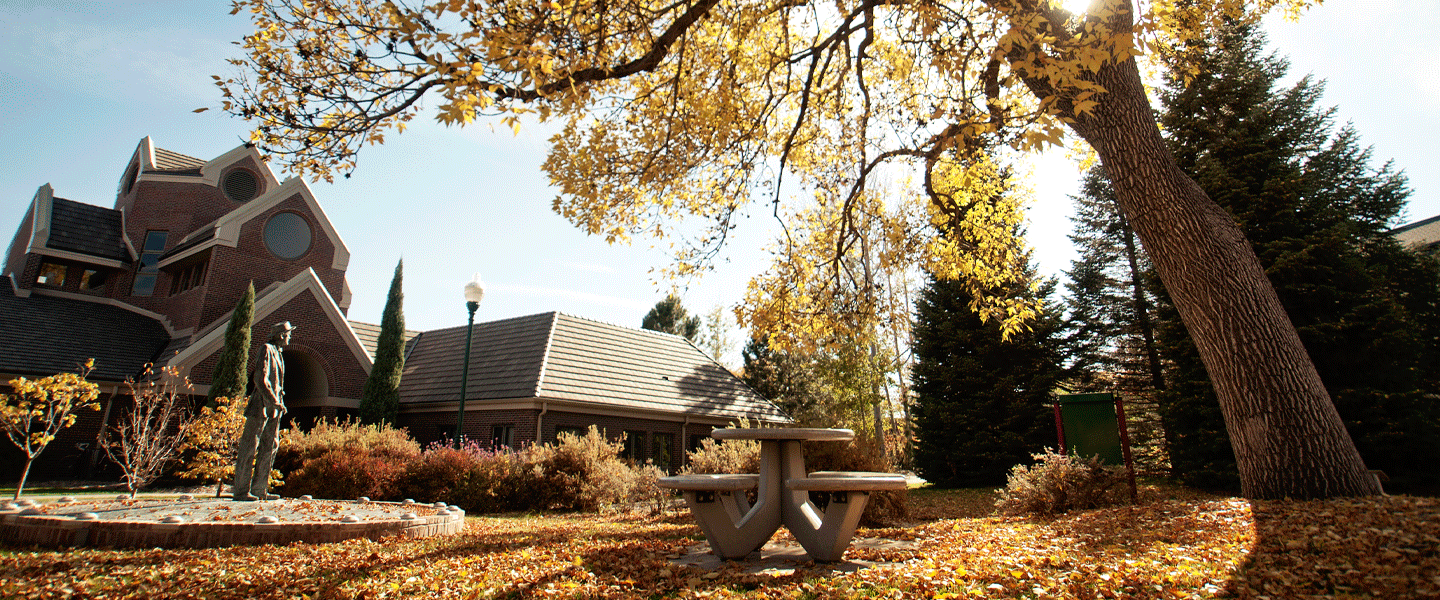 outside Coors with statue and table in fall