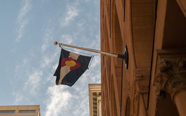 colorado flag flying from building downtown