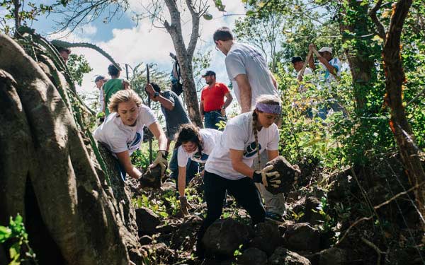 students help locals with landscape work