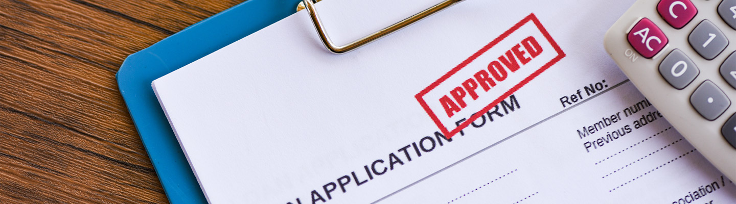 loan application approved on clipboard