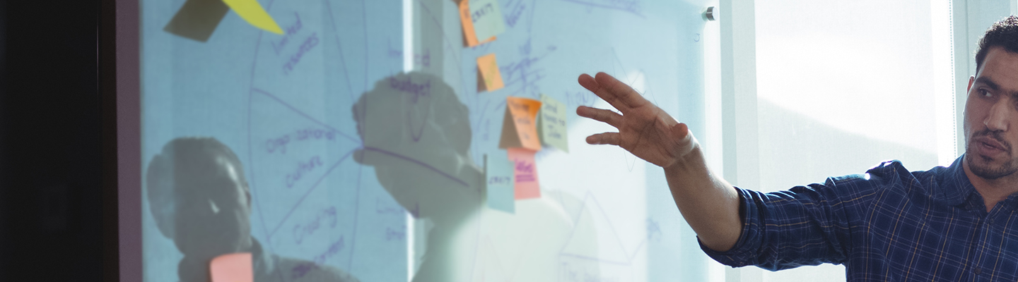 man pointing at evidence on white board