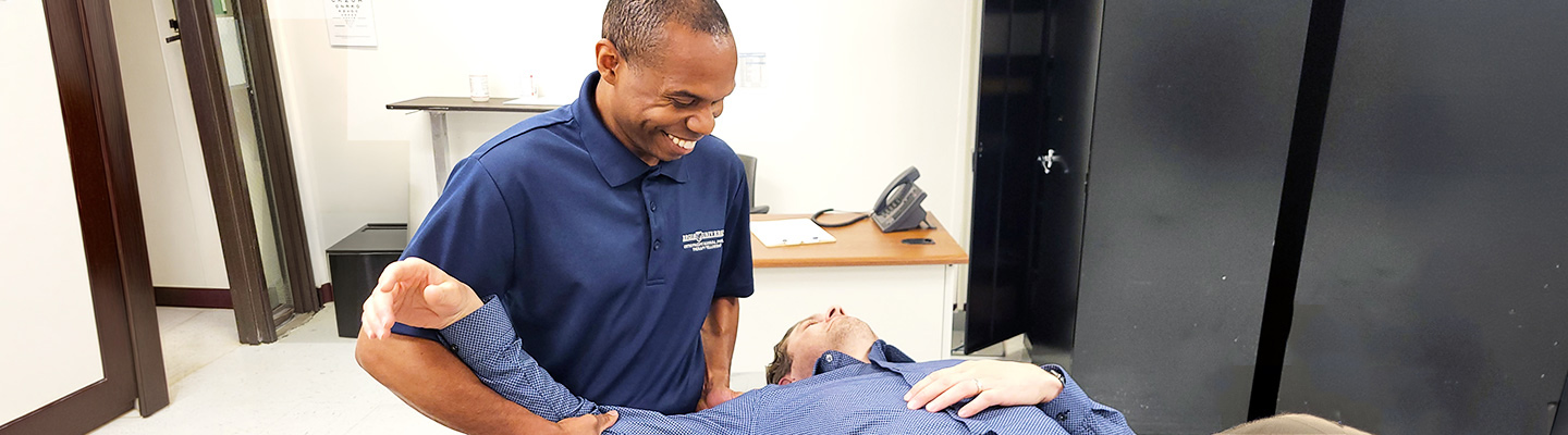 A Regis Physical Therapy Fellowship student works with a client in a classroom on the Denver, Colorado campus