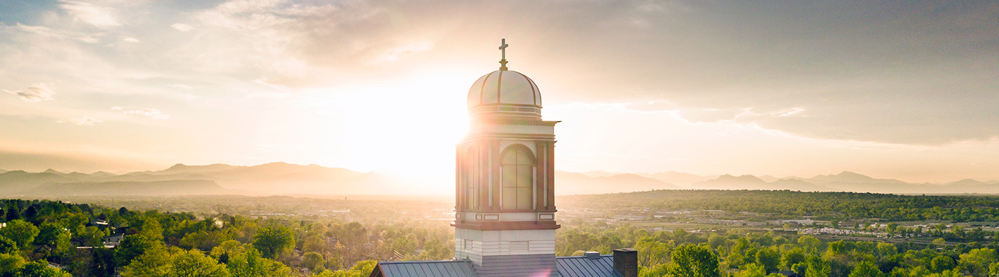 sunrise behind the cupola of historic main hall on on the Regis campus in Denver, Colorado