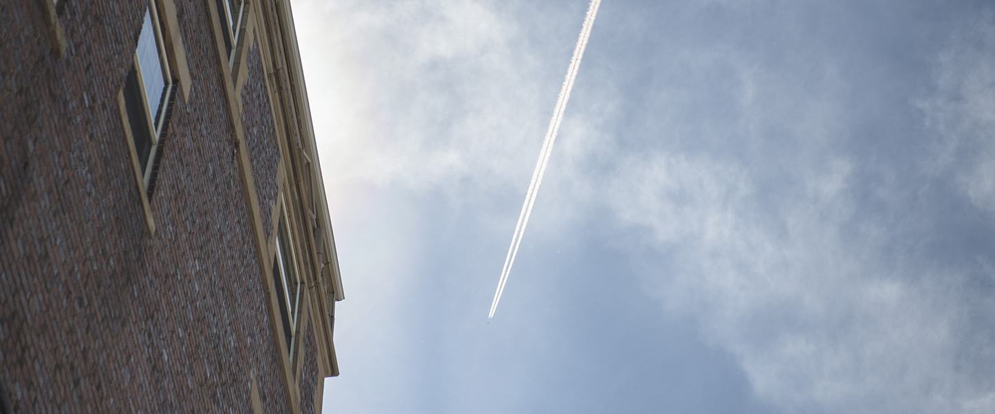 Plane flies across sky