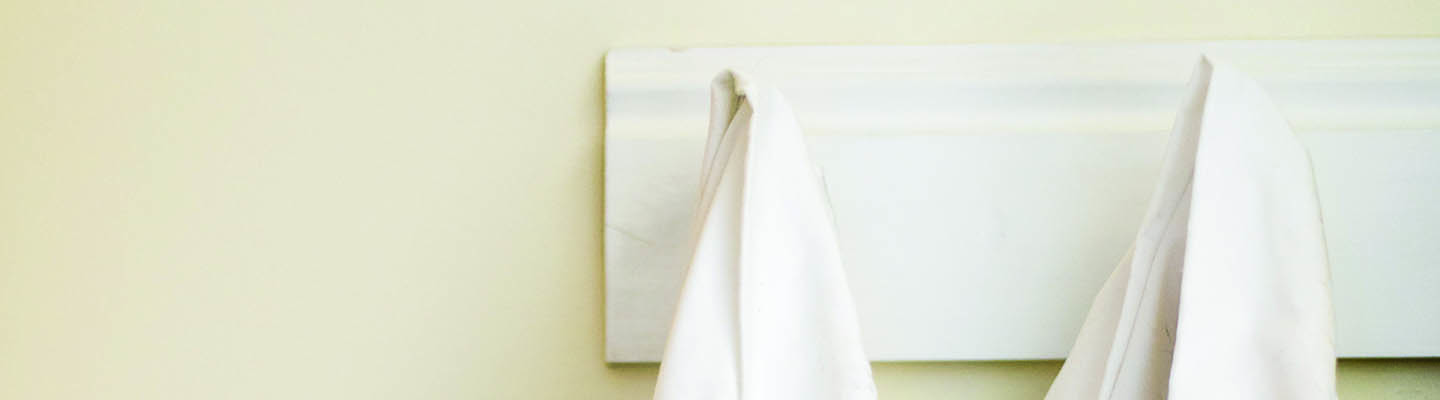 white medical coats hanging on coat rack
