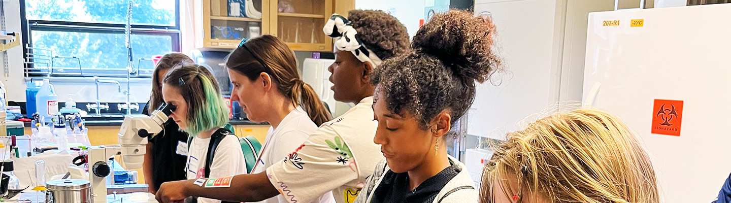campers perform scientific activities on lab equipment