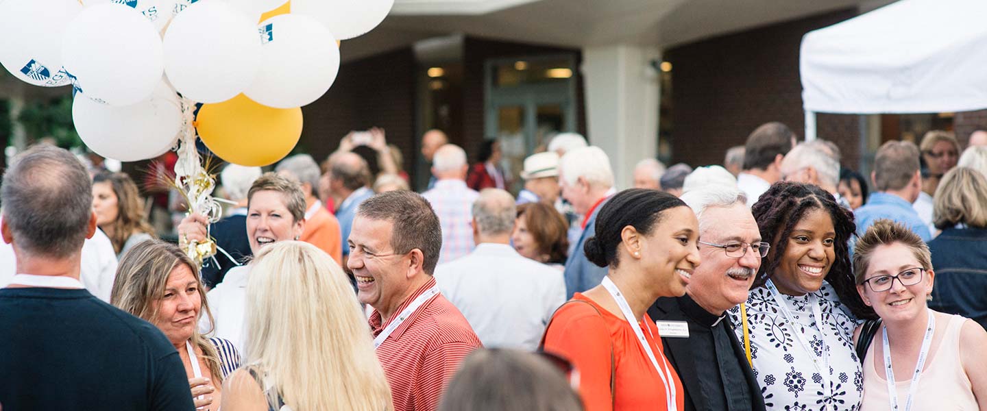 Regis alumni reliving old memories and friends on the Regis plaza for Alumni Weekend