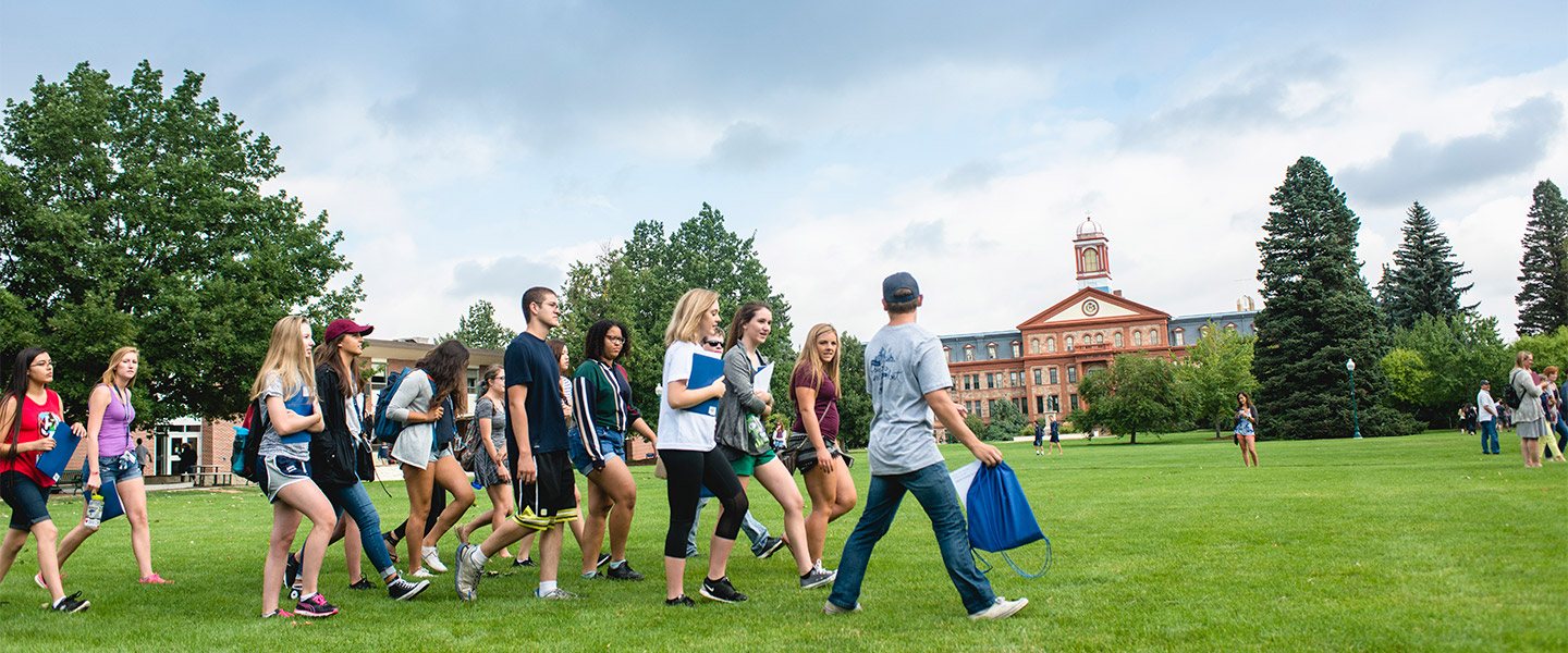 group of students walking across the quad image