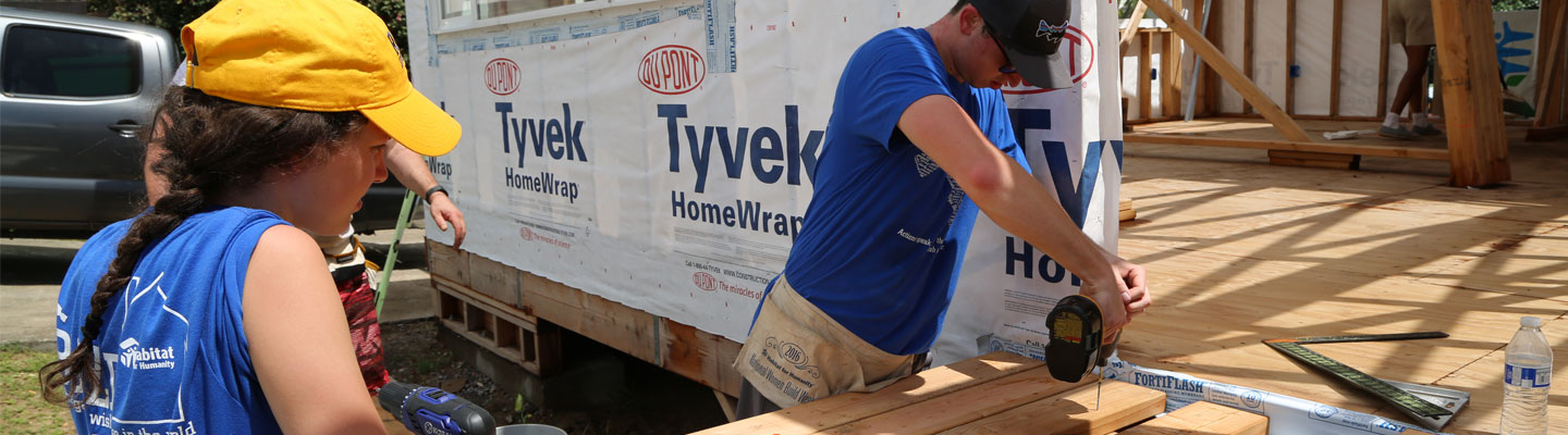 students cut wood during service project