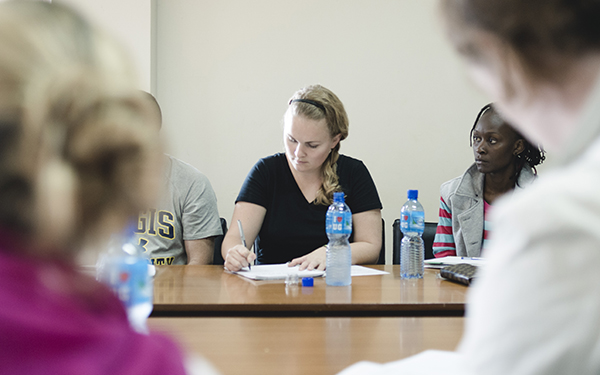 Students taking notes in a Regis class