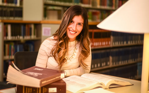 adult student in library, smiling