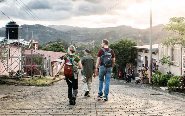 students walk down road during alternative spring break