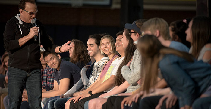 Alumni participating in an hypnotist event