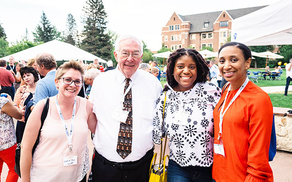 Alumni of all ages smile for the camera at Alumni Weekend on the Northwest Denver campus