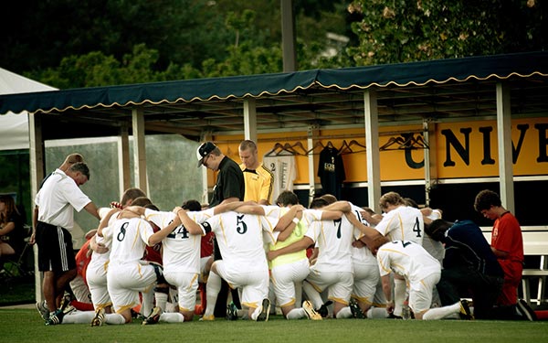 soccer team huddling