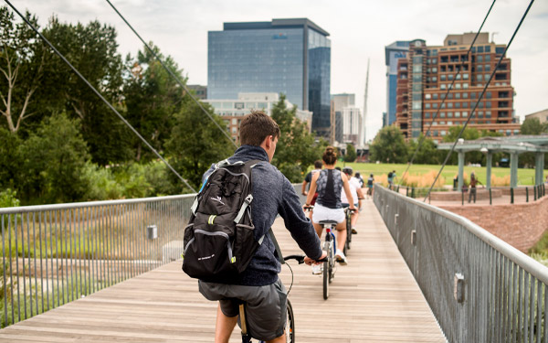students biking into downtown denver