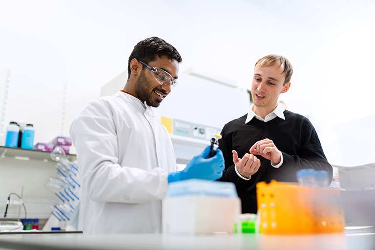 Bio medical researchers study samples in a lab