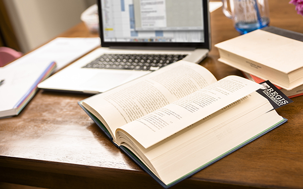 book and computer on table