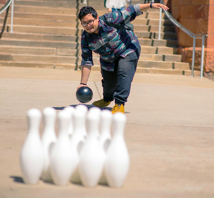 student bowling on the Quad