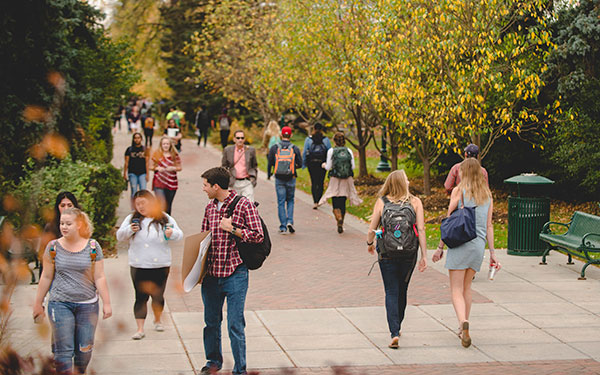 students walking on campus between classes