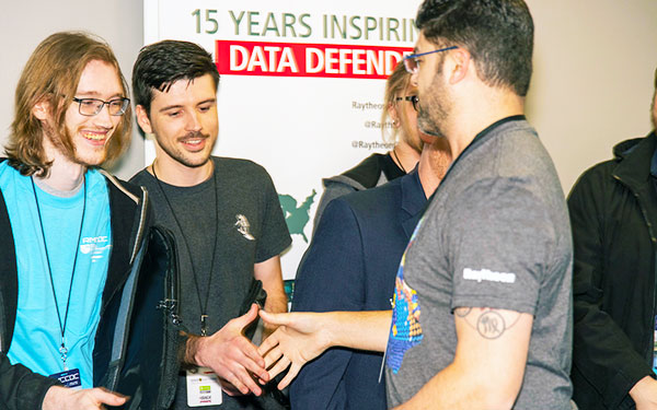 competitors shake hands at the end of the RMCCDC competition sponsored by the Center for Information Assurance Studies