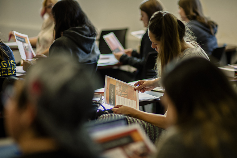 students look at handout in class