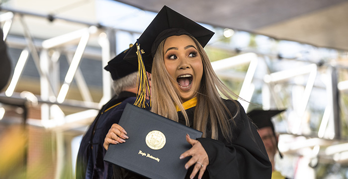 excited student after receiving diploma