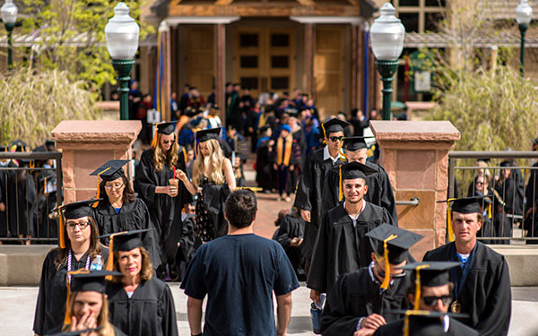 graduates in regalia walking