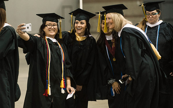 Students taking pictures and celebrating graduation