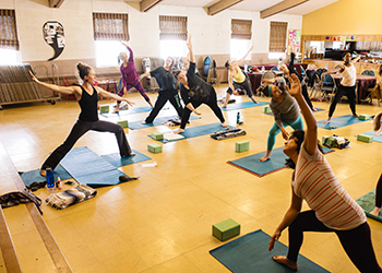 community members doing yoga in gymnasium