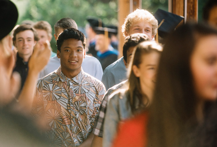 crowd of students walking on the sidewalk