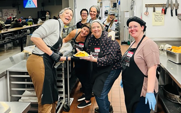 Regis nursing faculty pose for a photo in the kitchen at the Denver Rescue Mission