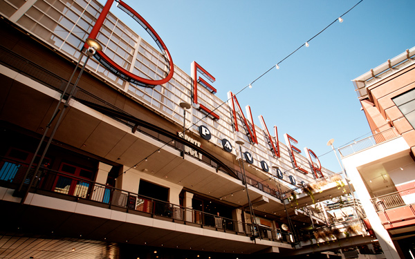 Looking up at the Denver Pavilions sign and open-air shopping center in downtown Denver