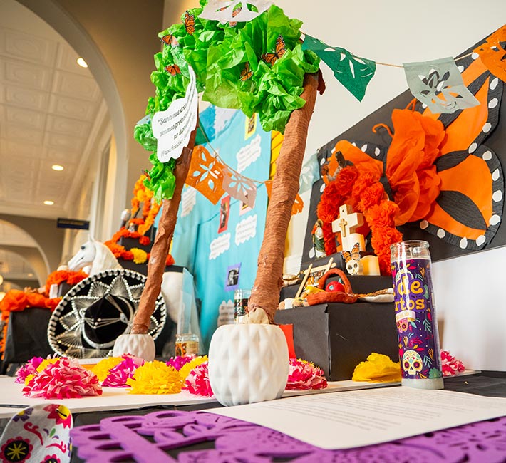 altarcitos made of colorful paper and mixed materials on display in Main Hall on the Denver campus during Dia de Muertos