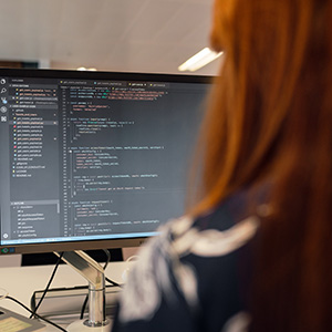 Woman coding at a computer