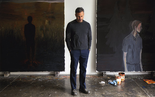 Enrique Martinez Celaya posing in front of his artwork