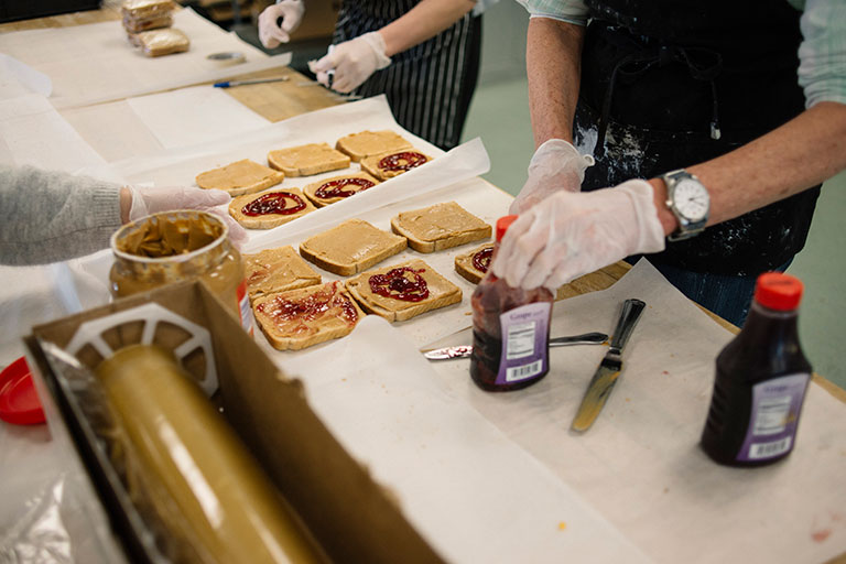 Volunteers making sandwiches for people in need