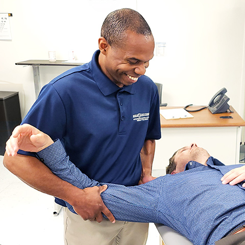 A Regis Physical Therapy Fellowship student works with a client in a classroom on the Denver, Colorado campus