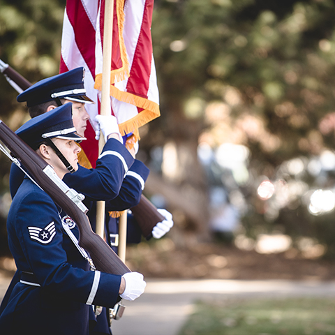 woman in military dress stands at attention