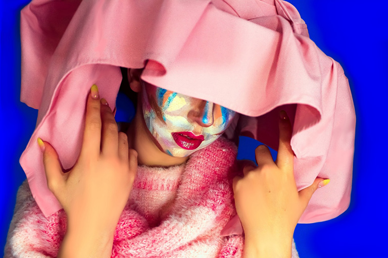 photo of a woman wearing elaborate makeup and an extravagant hat