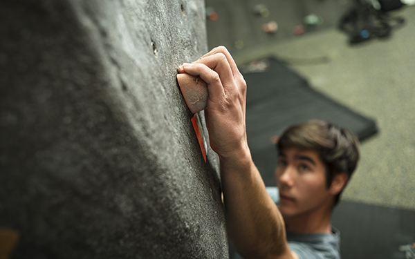 student climbing on indoor rock wall