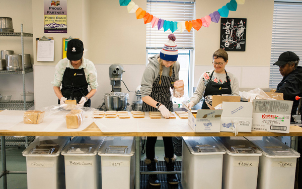 Student preparing food to be distributed to members of the Denver community.