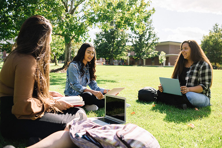 freshman students enjoying the Regis quad