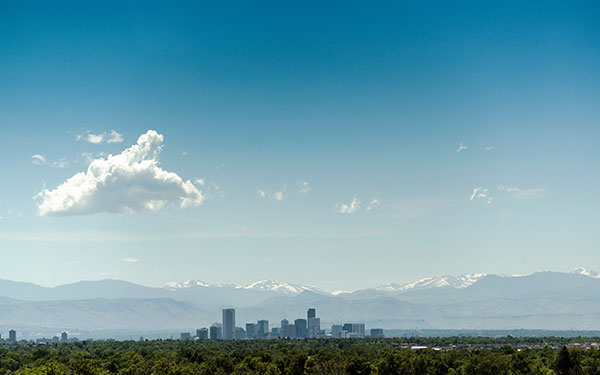 Denver skyline in front of snowy mountains