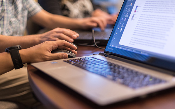 hands at computer