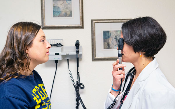 a doctor examines a patient in the student health center