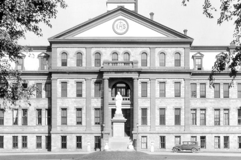 Historic black and white image of the front exterior of Main Hall
