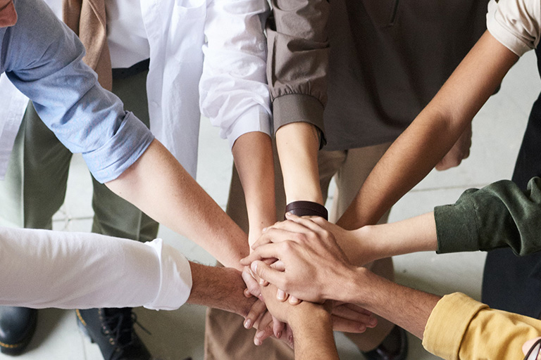 hands in the center for a huddle